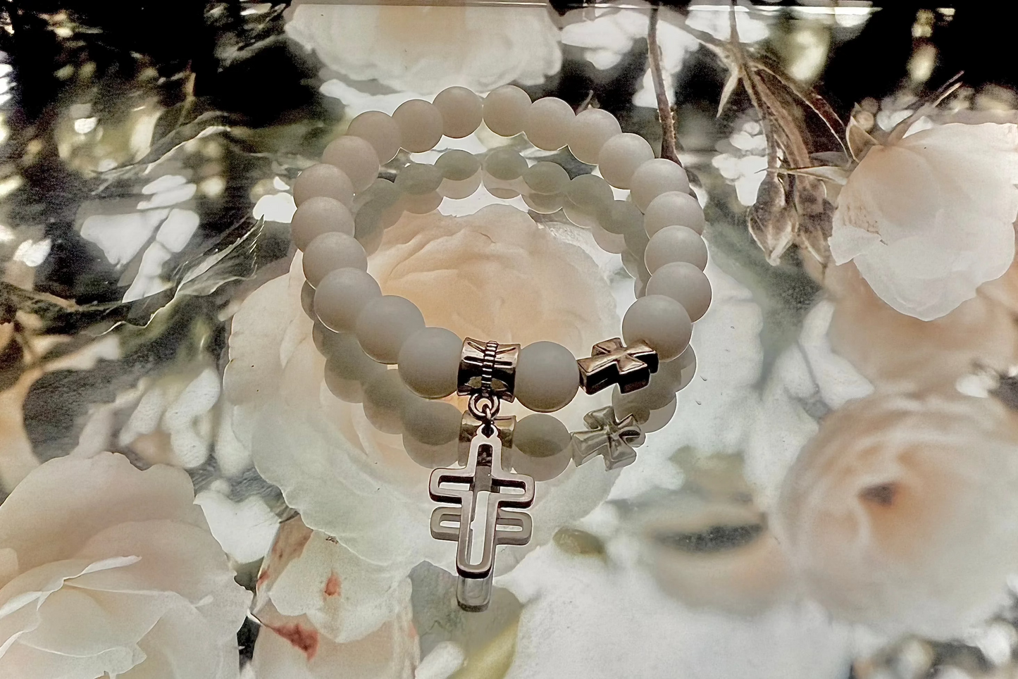Medium sized beaded bracelet with cross pendant.